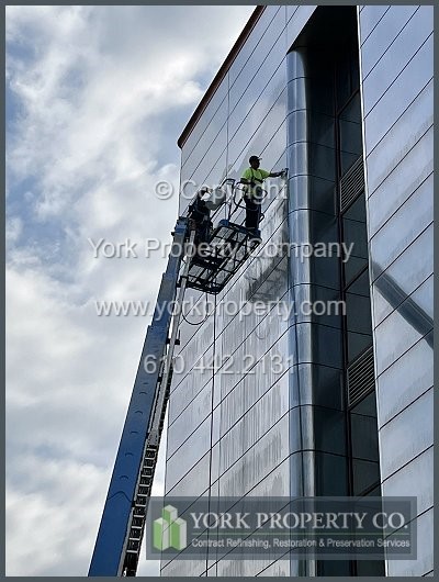 Local contractor restoring weathered stainless steel building facade siding panels, uneven stainless steel building facade refinishing, oxidized stainless steel building facade restoration and scratched stainless steel building facade chemical cleaning solutions.