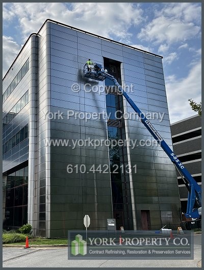 Local company fixing degraded stainless steel facade clad panels.