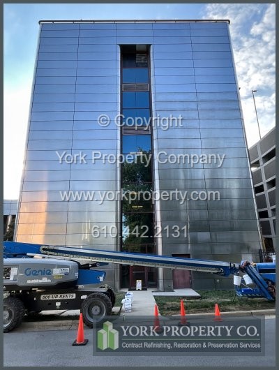 Dirty stainless steel building facade panel cleaning.