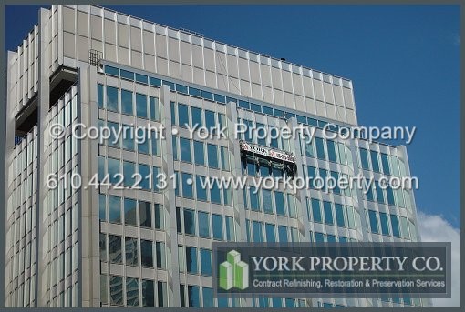 Weathered anodized aluminum curtain wall window mullion and panel cleaning, refinishing and restoration methods and materials.