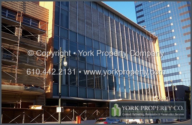Dull, grimy, ultraviolet UV sun damaged, stained, faded and bleached clear anodized aluminum building facade cleaning and window frame refinishing.
