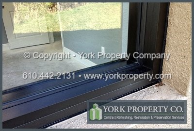 Clean Dryvit EIFS off of anodized aluminum interior window frames, solvent wipe clean old duct tape residue off of anodized aluminum and wash sticky glue adhesives off of anodized aluminum window frames.