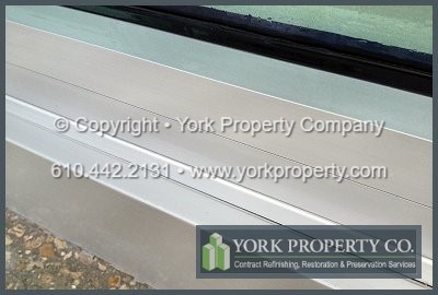 Cleaning streaky lines off of anodized aluminum window wall panels systems.