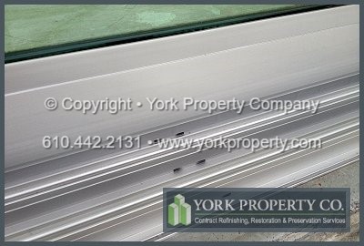Chemically cleaning anodized aluminum clad panels. Solvent washing anodized aluminum siding panels. Washing water streaks off of anodized aluminum window frames.