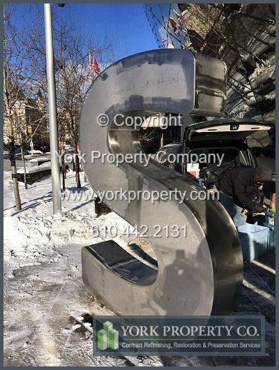 On-site exterior stainless steel sign refinishing.