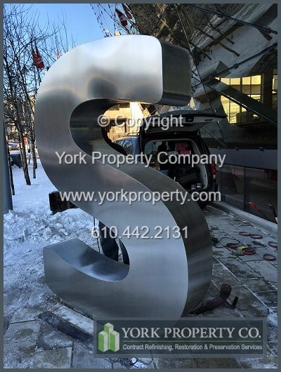 On-site exterior stainless steel sign refinishing.