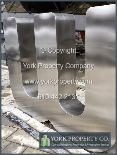 On-site exterior stainless steel sign refinishing.