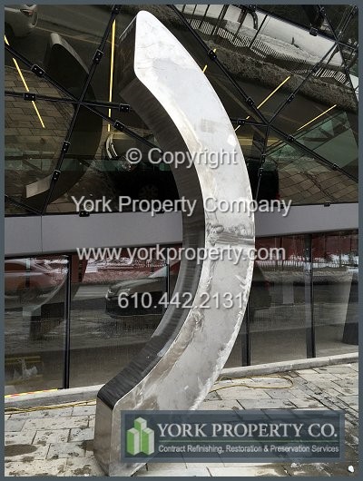 On-site exterior stainless steel sign refinishing.