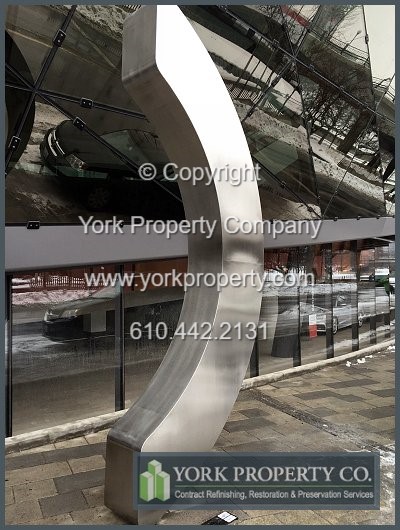 On-site exterior stainless steel sign refinishing.