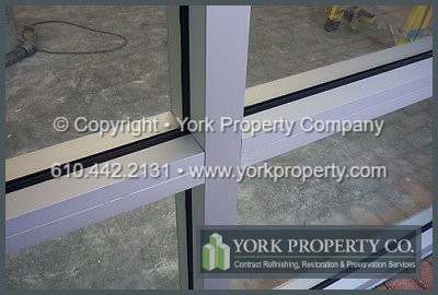 Cleaning dirty anodized aluminum curtain wall panels, restoring stained anodized aluminum building façade panels, refurbishing soiled anodized aluminum cladding, refinishing grimy anodized aluminum clad paneling.