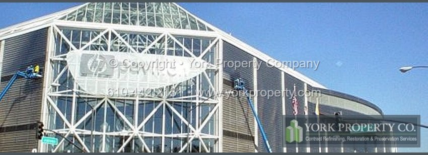 Local company washing dirty stainless steel building facade clad panels.