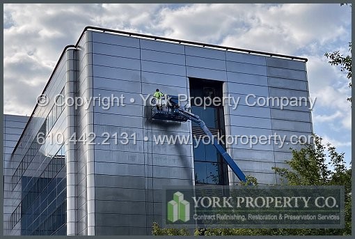 Repairing damaged stainless steel building facade panels.