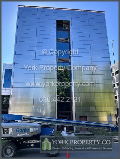 Restoring oxidized stainless steel building facade panels.