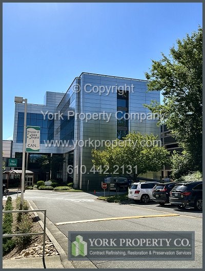 Exterior stainless steel building facade panel restoration.