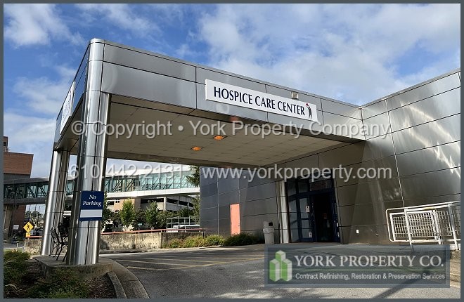 Local service that cleans dirty stainless steel building facade panels.