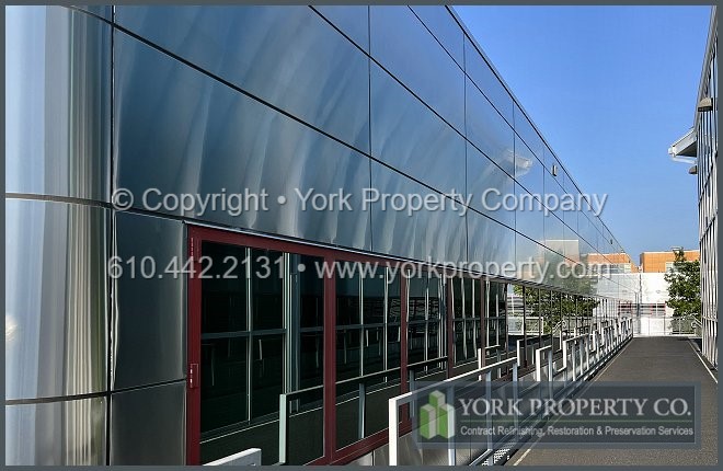 Contractor that cleans old stainless steel building facade panels.