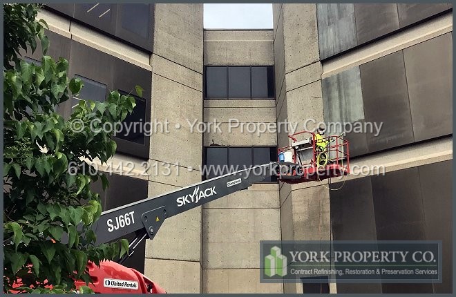 A company that cleans corrosion off of the surface of tarnished building facade panels.