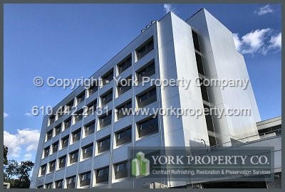 On-site exterior stainless steel panel refinishing.