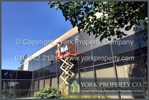 A contractor that gets old flaking lacquer off of anodized aluminum building facade panels.