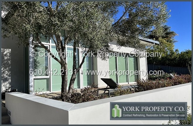Refinishing oxidized anodized aluminum window frames.