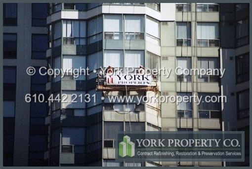 Curtain wall restoration cleaning and restoring faded and bleached painted aluminum.
