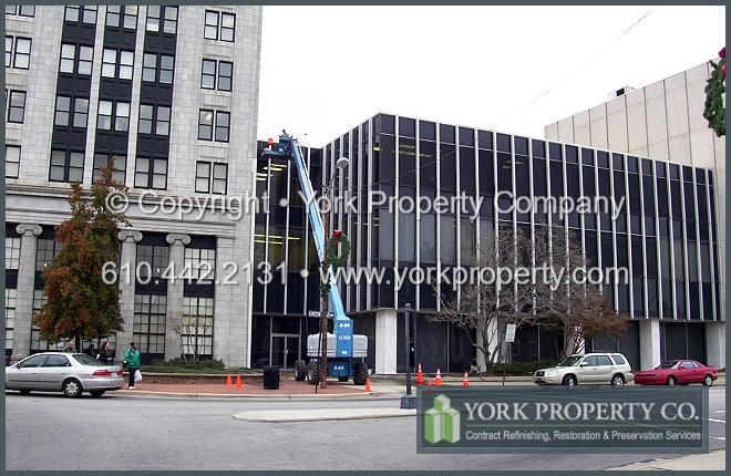 Damaging anodized aluminum, corrosive, acidic and caustic environmental contaminants adversely affect the corrosion protection and performance of exterior anodized aluminum cladding, window frames, siding and spandrel panel surface finishes.