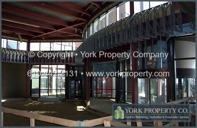 Unprotected, damaged, stained and contaminated bronze anodized aluminum new window frames, anodized aluminum window casings and anodized aluminum window mullions.