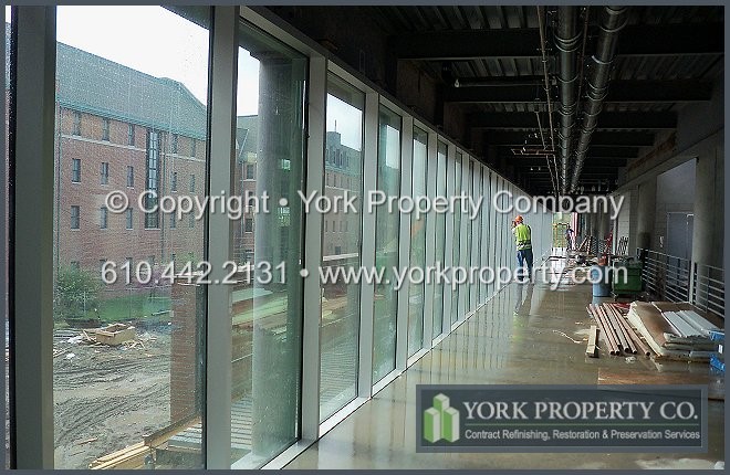 Washing acid etching stains from anodized aluminum window frame sills and flashing.