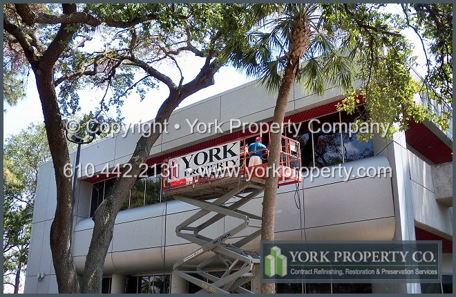 Acid etching stained anodized aluminum commercial building panel cleaning and restoration.