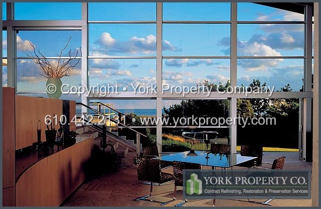 Removing acid etching and corrosion stains from damaged exterior clear anodized aluminum.