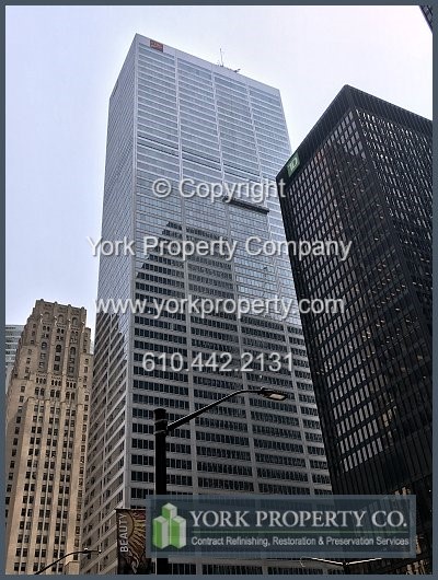 Washing stained stainless steel curtain wall panel restoration.