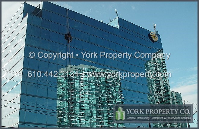Cleaning, repairing and refinishing curtain wall faded paint restoration.