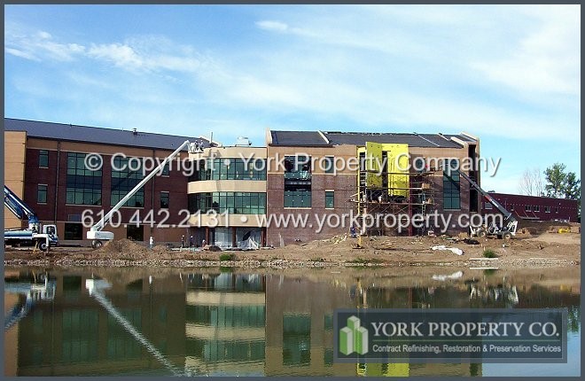 Concrete and mortar stained, lime and acid etched, oxidized anodized aluminum window frame, anodized aluminum storefront, anodized aluminum doors construction cleaning and oxidation removal.