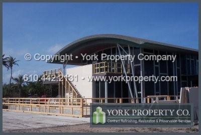 Refinishing and repairing stainless steel clad panel siding surfaces that were flash oxidized by exposure to salt water and salt air mist. Protecting stainless steel window frames finishes from salt water damage.