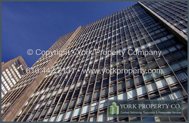 Old and deteriorated bronze anodized aluminum curtain wall restoration consulting.