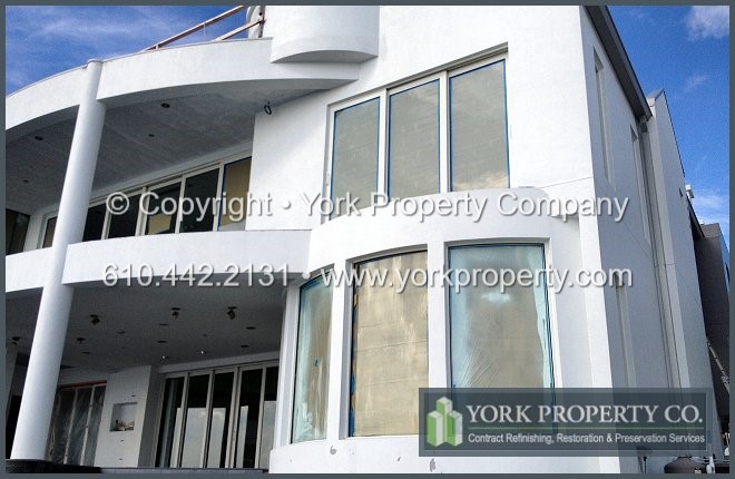 Protecting, preserving, sealing, refurbishing, painting, maintaining, repairing and refinishing painted aluminum building facade panels, ground floor storefront window frames and entrance doors.
