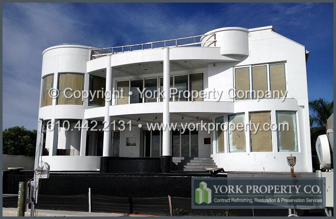 Cleaning, refurbishing, repairing and restoring chalked, faded, hard water stained, oxidized and stained exterior building facade painted aluminum panels, window mullions and storefront window frames and doors.