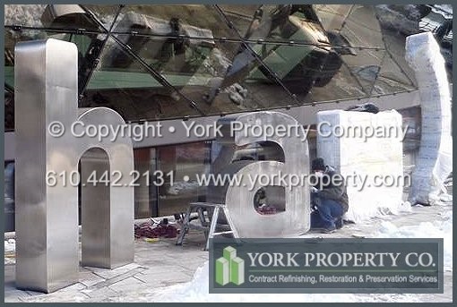 On-site exterior stainless steel sign refinishing.