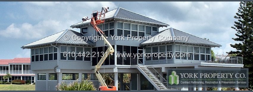 Professional service company cleaning rust off of stainless steel panels that are exposed to the ocean front salt water.