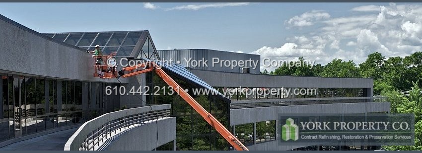 Cleaning dirty staineless steel building facade clad panels.