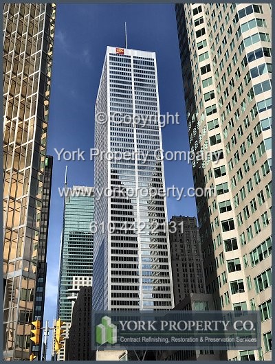 Cleaning dirty stainless steel clad curtain wall panels.