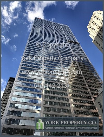 Cleaning dirty stainless steel curtain wall clad panels. Stripping old paint off of anodized aluminum window frames.