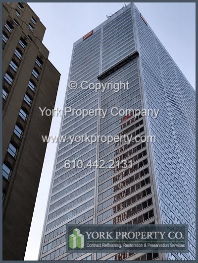 Dirty stainless steel curtain wall panel cleaning.