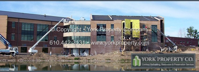 Restoration cleaning acid etched bronze anodized aluminum window frames.