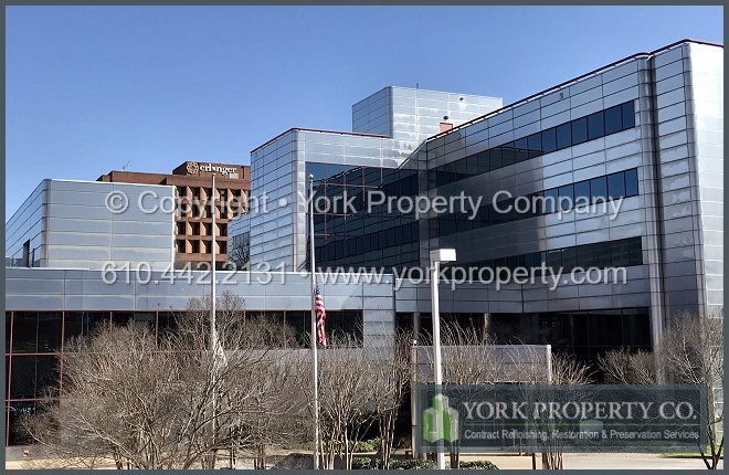 Stainless steel building facade metal panel restoration cleaning and repair.