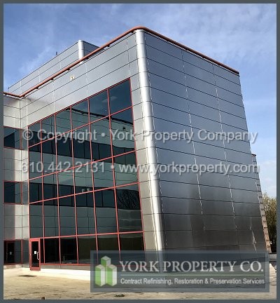 Washing stained exterior stainless steel building facade panels.