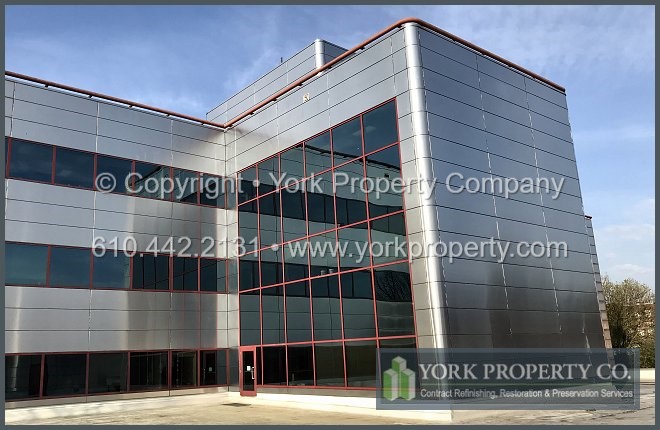 Repairing damaged metal panels in an exterior building facade.