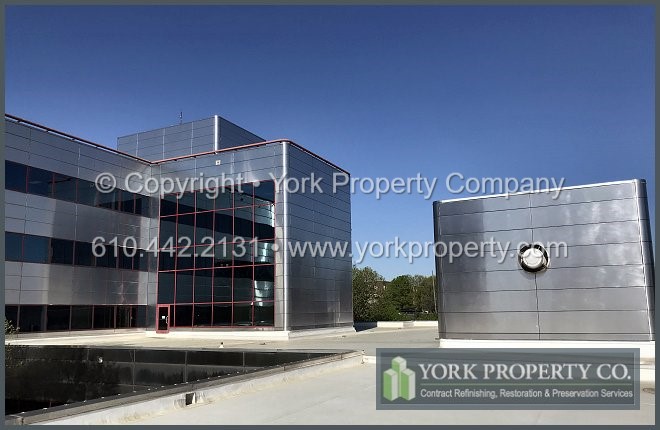 Contractor cleaning dirty metal clad panels.