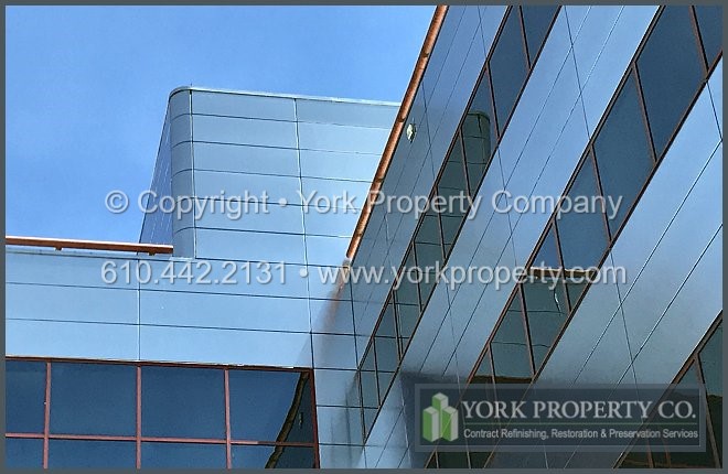 Contractor that cleans old metal building facade panels.