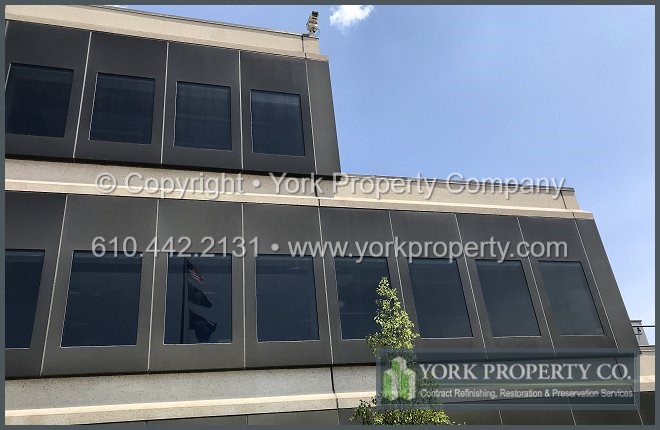 Refurbishing the sheen on stained anodized aluminum building facade paneling.